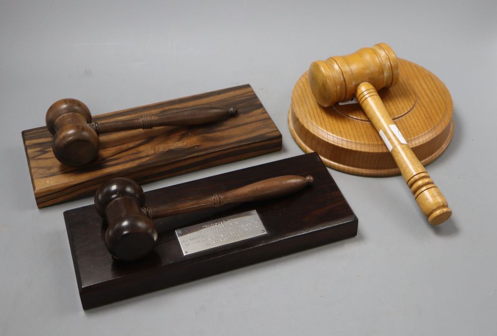 Two presentation wood gavels and another, all on stands